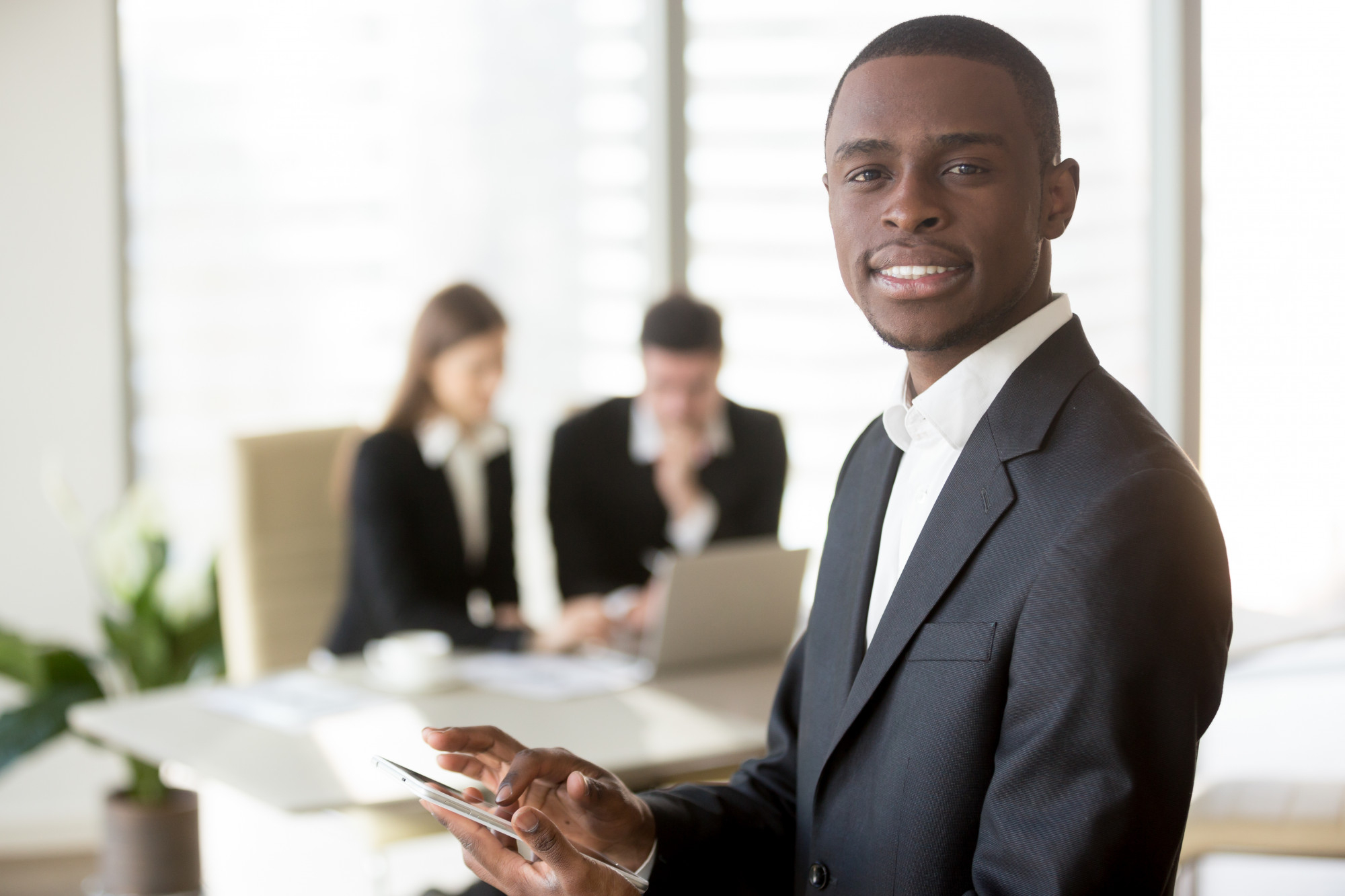 black-businessman-using-digital-tablet-meeting_347.jpg